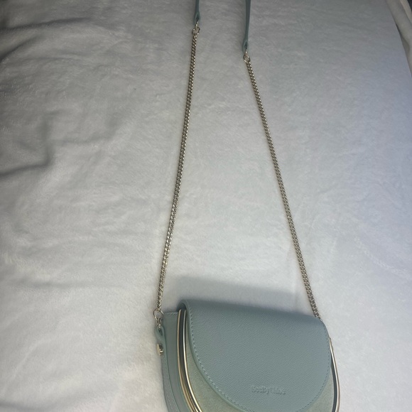 A high-shine bar adds definition to the half-circle silhouette of this elegant. - Picture 3 of 6